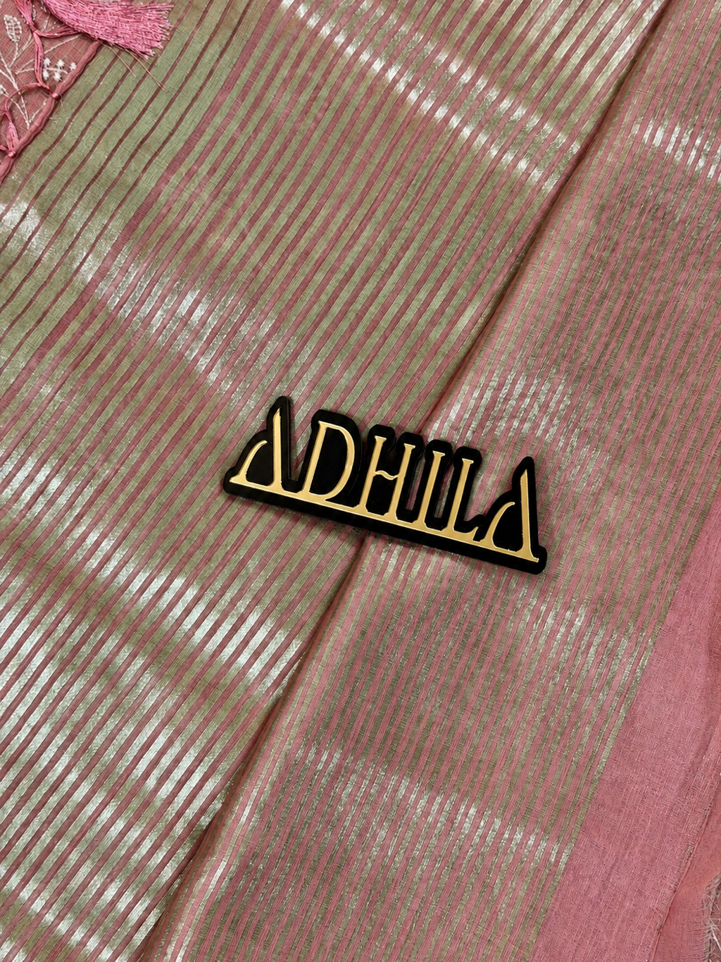 Dusty Rose Pink Floral Tissue Saree – close-up of fabric texture with Adhila logo