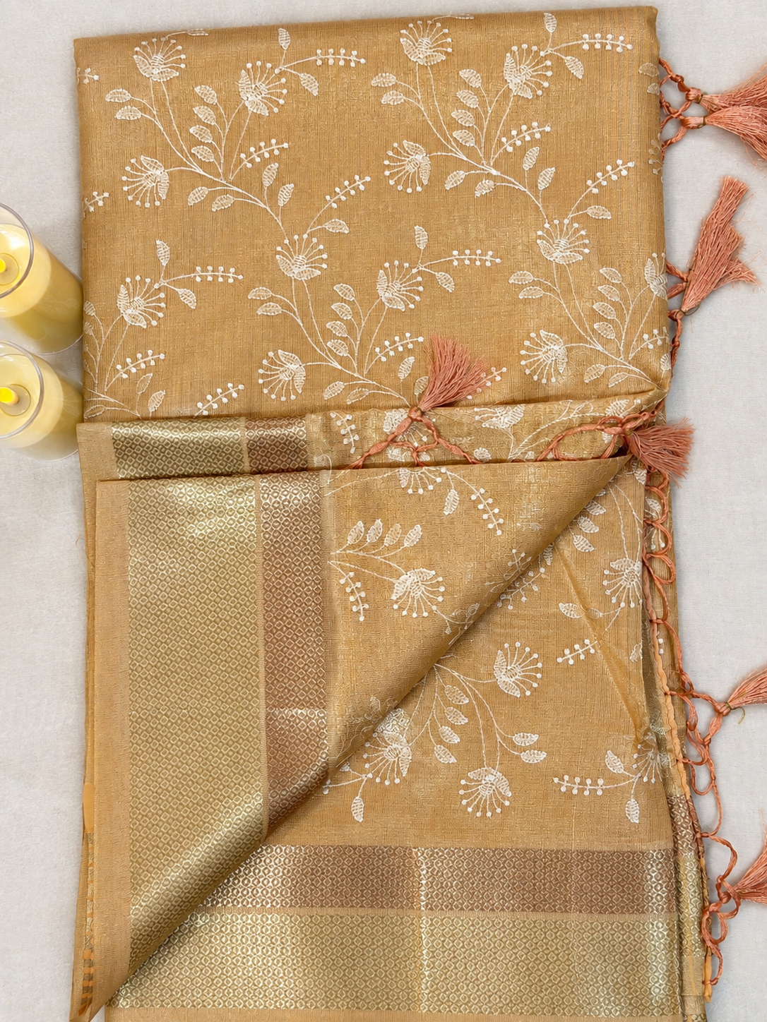 Terracotta Orange Floral Tissue Saree – border and pallu detail with tassel finish