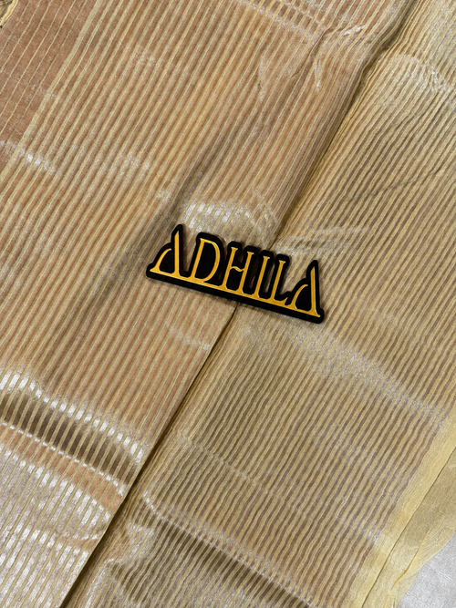 Golden Yellow Floral Tissue Saree – close-up of zari striped pallu with Adhila logo